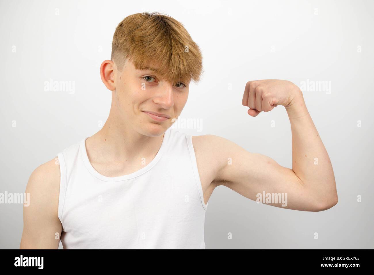 Portrait of a 14 year old caucasian teenage boy wearing a sleeveless