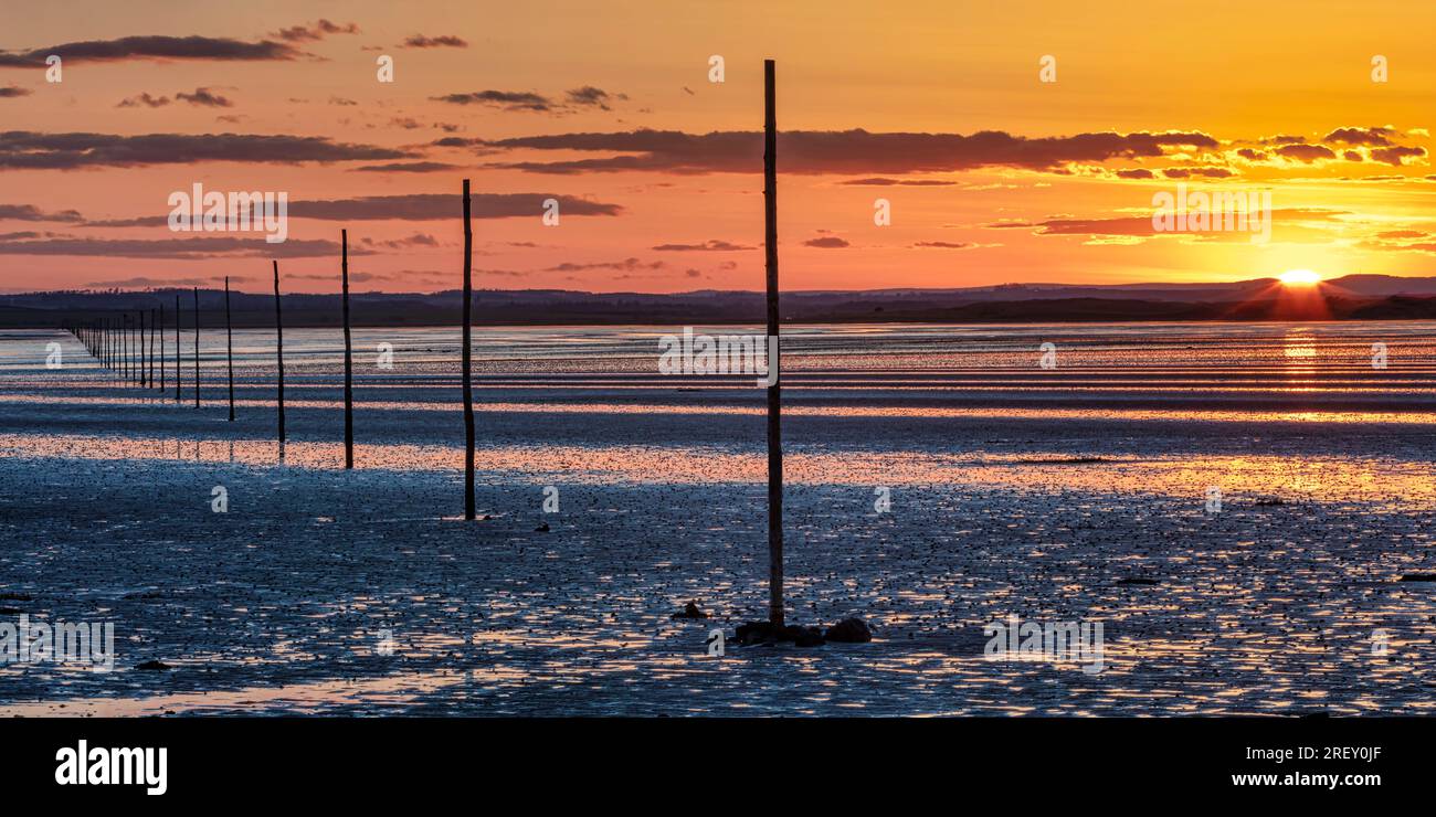 Sunset in Summer over the Pilgrim's Causeway on the Holy Island of Lindisfarne in Northumberland, England, United Kingdom Stock Photo