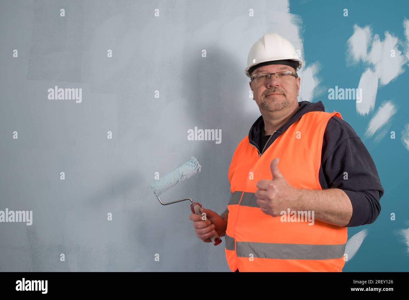 Primary coat of paint. Ground coat of light paint on a dark wall Stock