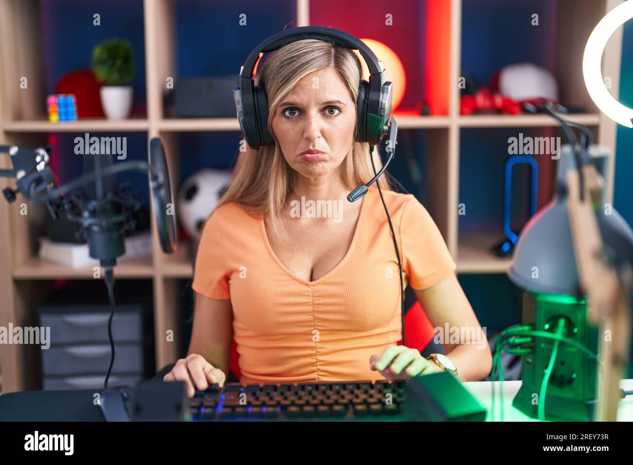 Young woman playing video games depressed and worry for distress, crying angry and afraid. sad