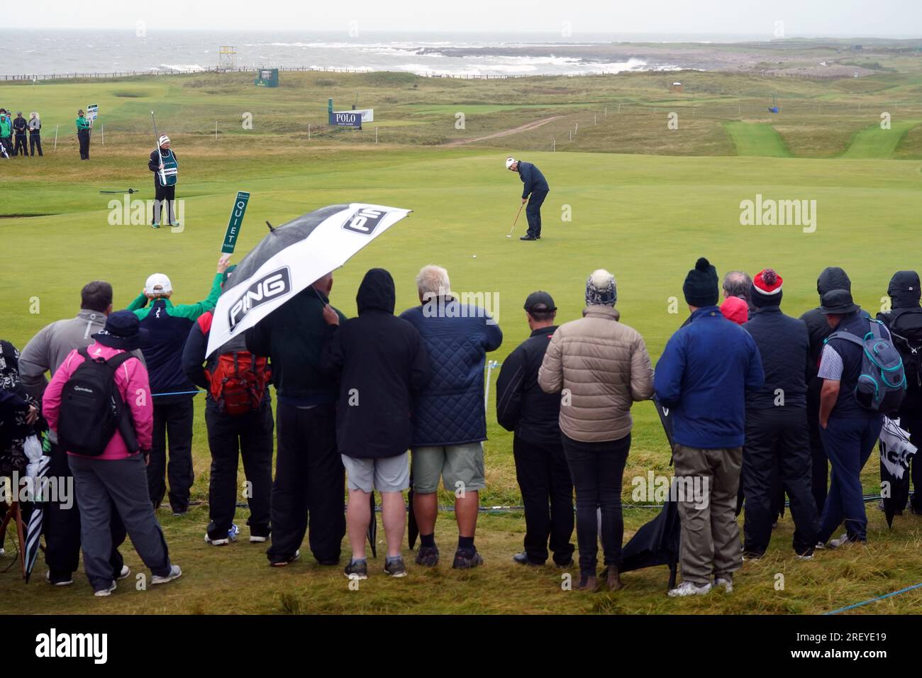Crowds watch Padraig Harrington putting on the 17th green during day