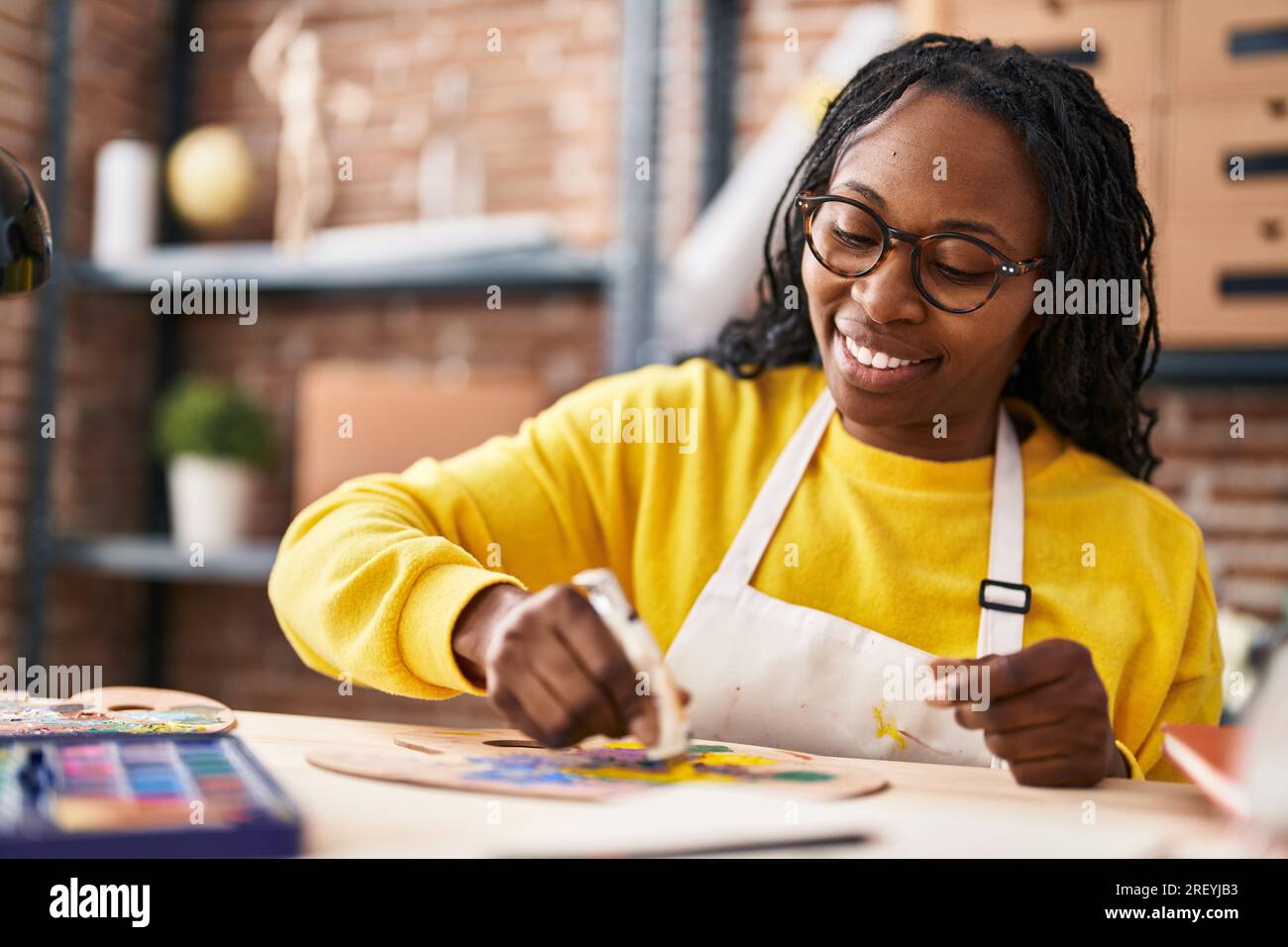 African american woman artist smiling confident mixing color at art studio Stock Photo