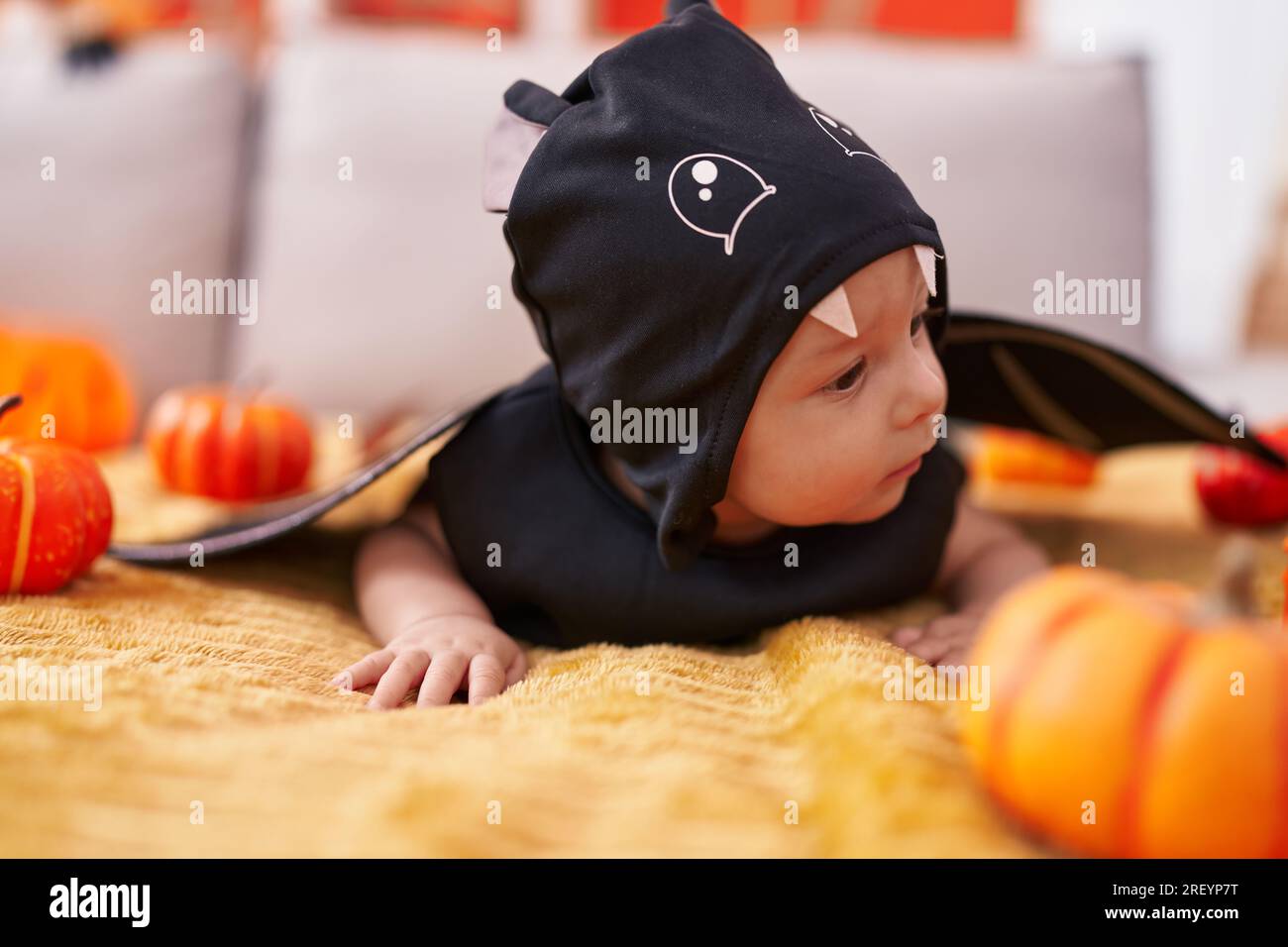 Adorable caucasian baby wearing bat costume lying on sofa at home Stock  Photo - Alamy