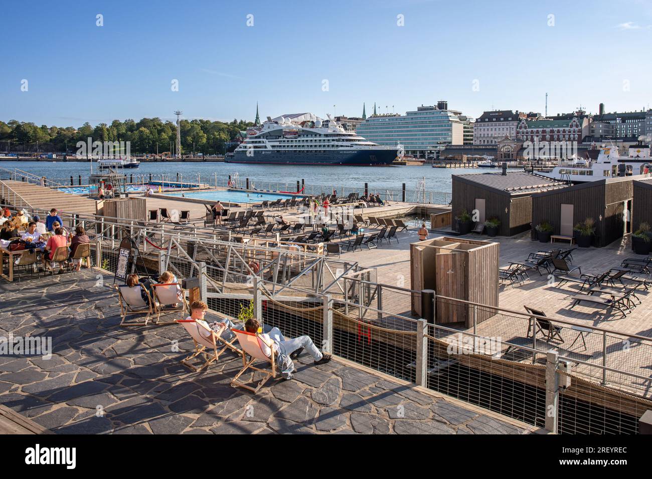 Allas Sea Pool outdoor spa on a floating deck in evening sunshine. Helsinki, Finland. Stock Photo