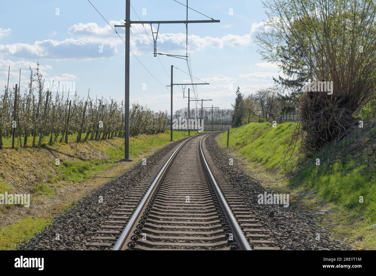 Railway lines perspective countryside in the middle of railway tracks. spring sky Stock Photo