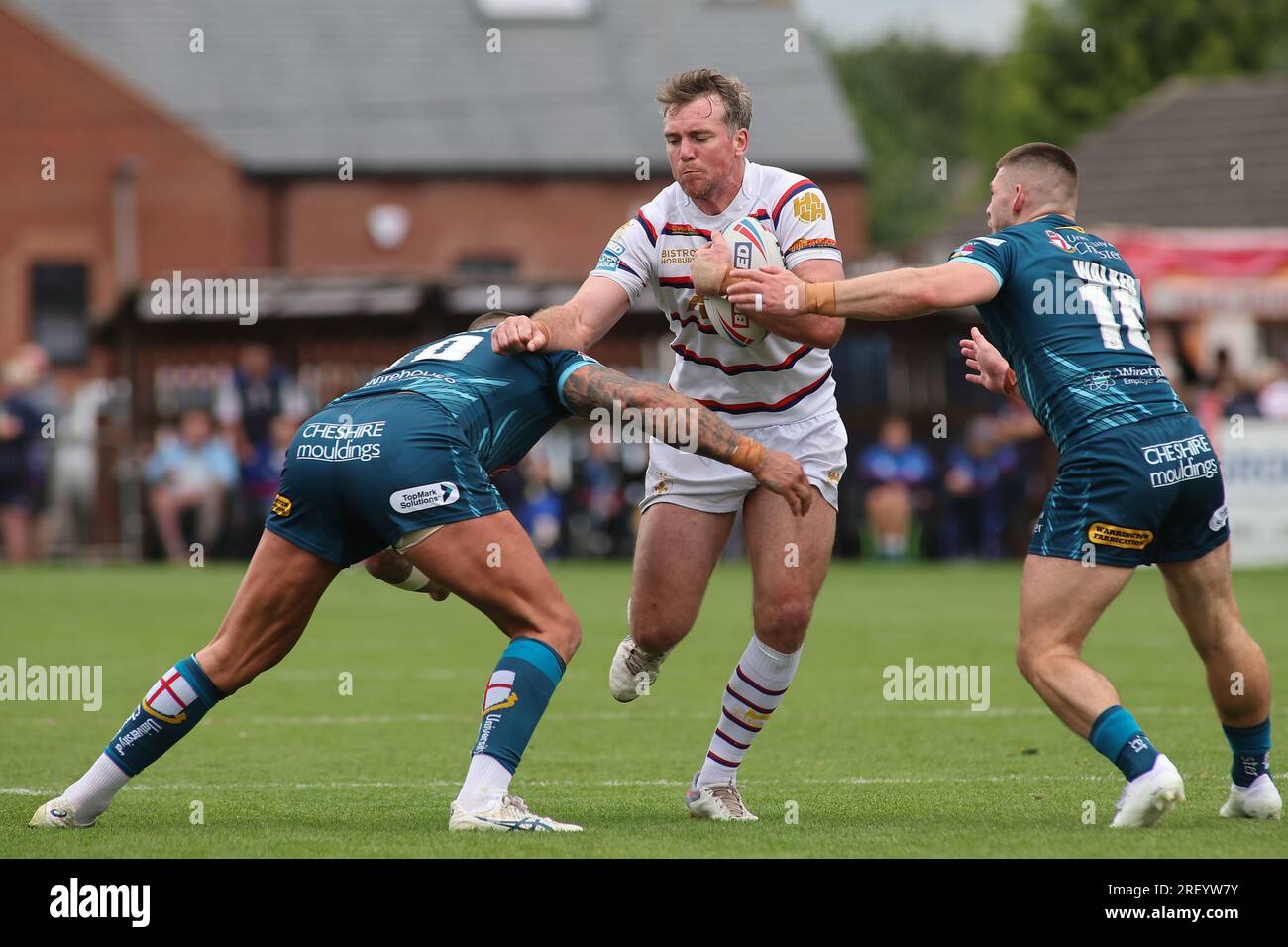 Wakefield, UK. 30th July, 2023. Be Well Support Stadium, Wakefield, West Yorkshire, 30th July 2023. Betfred Super League Wakefield Trinity vs Warrington Wolves Matty Ashurst of Wakefield Trinity tackled by Paul Vaughan and Danny Walker of Warrington Wolves Credit: Touchlinepics/Alamy Live News Stock Photo