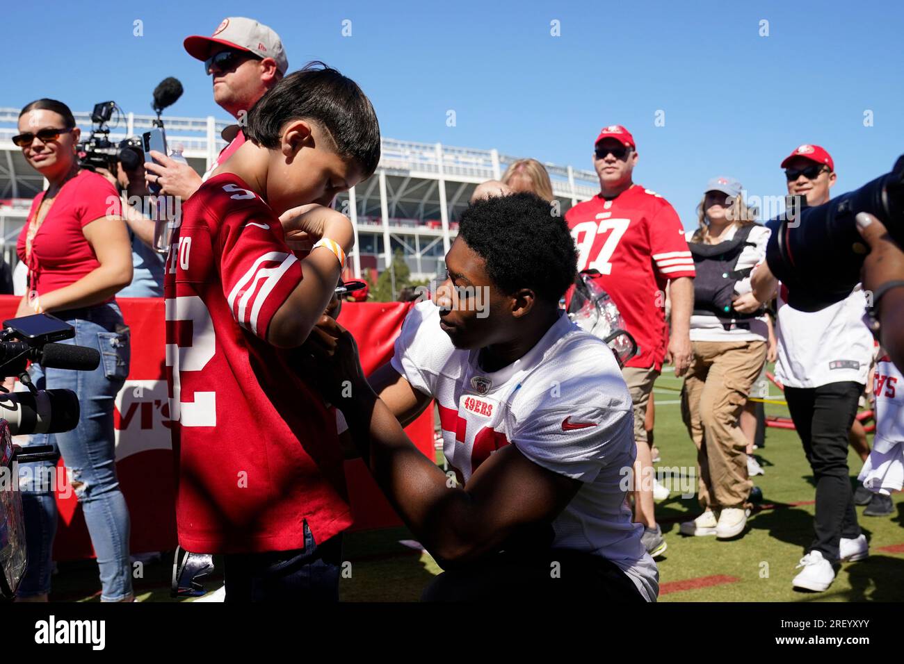 San Francisco 49ers linebacker Jalen Graham center signs a fan s