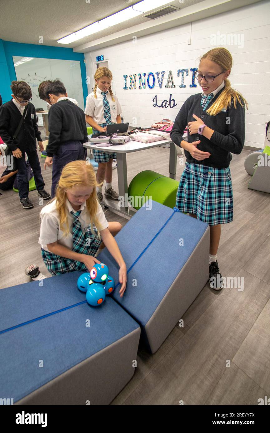https://c8.alamy.com/comp/2REYY7X/uniformed-girls-at-a-catholic-middle-schools-stem-based-innovation-lab-in-garden-grove-ca-test-the-mobility-of-of-a-dash-robot-able-to-move-in-i-2REYY7X.jpg