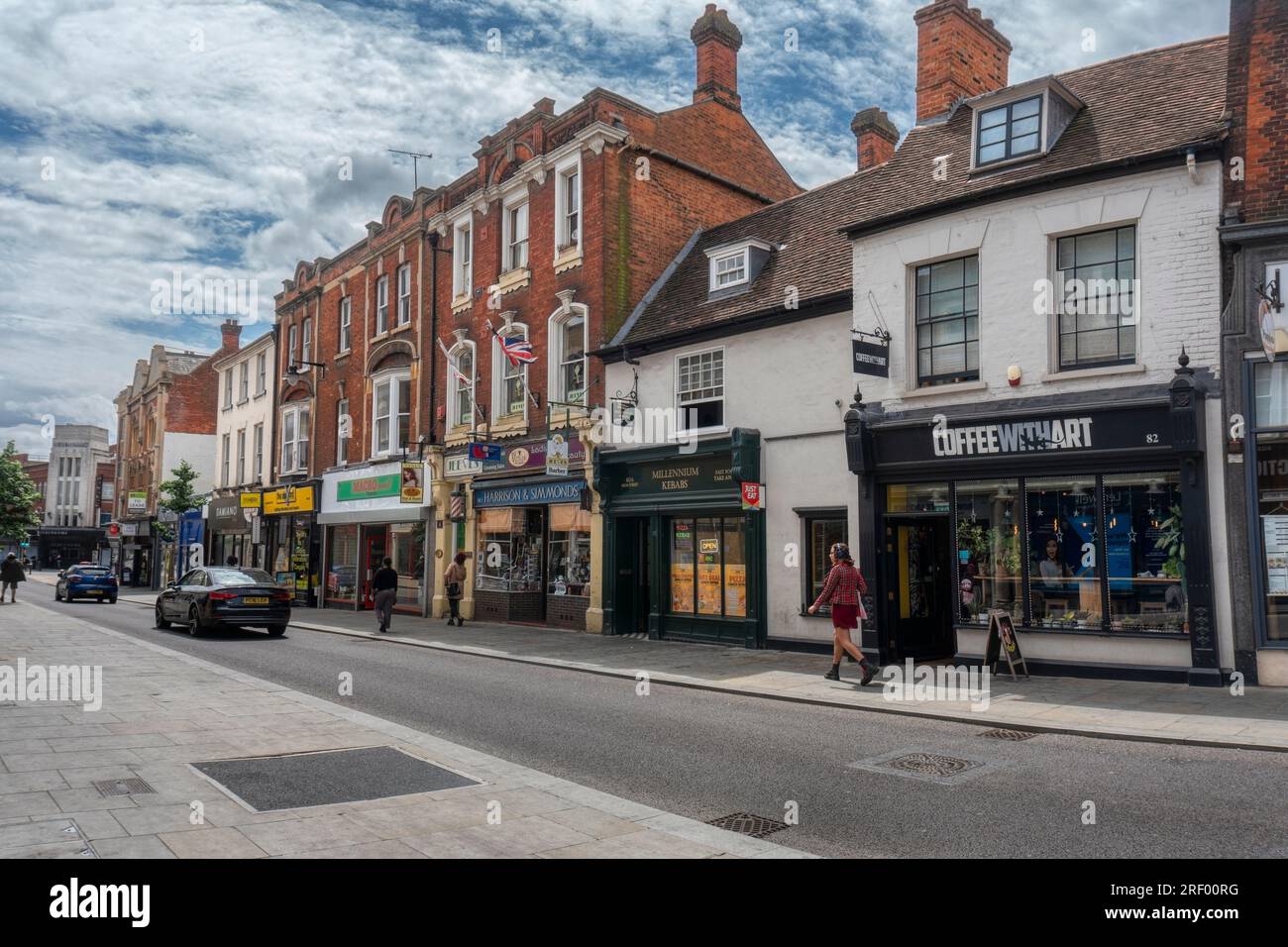 UK, Bedford, 3 July 2023, editorial ,commercial street, several shop fronts and people walking on the street Stock Photo