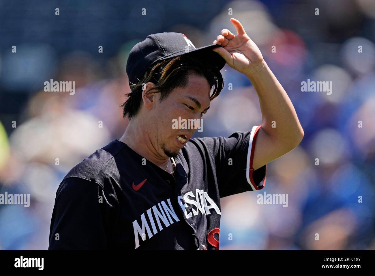 Minnesota Twins starting pitcher Kenta Maeda, from Japan, walks to the  dugout after throwing during the first inning of a baseball game against  the Kansas City Royals Sunday, July 30, 2023, in