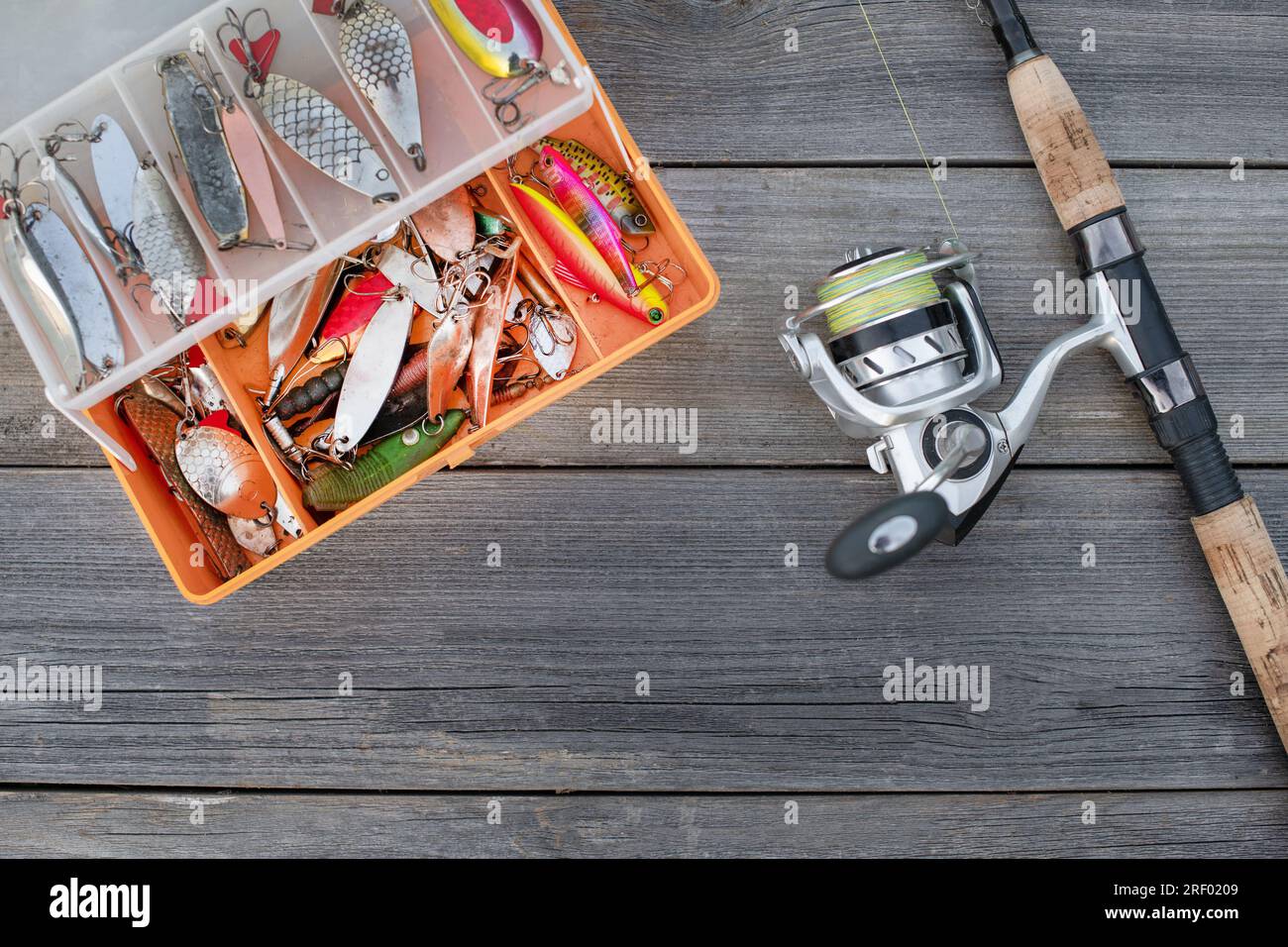 A fishing tackle box, complete with lures and fishing gear on a