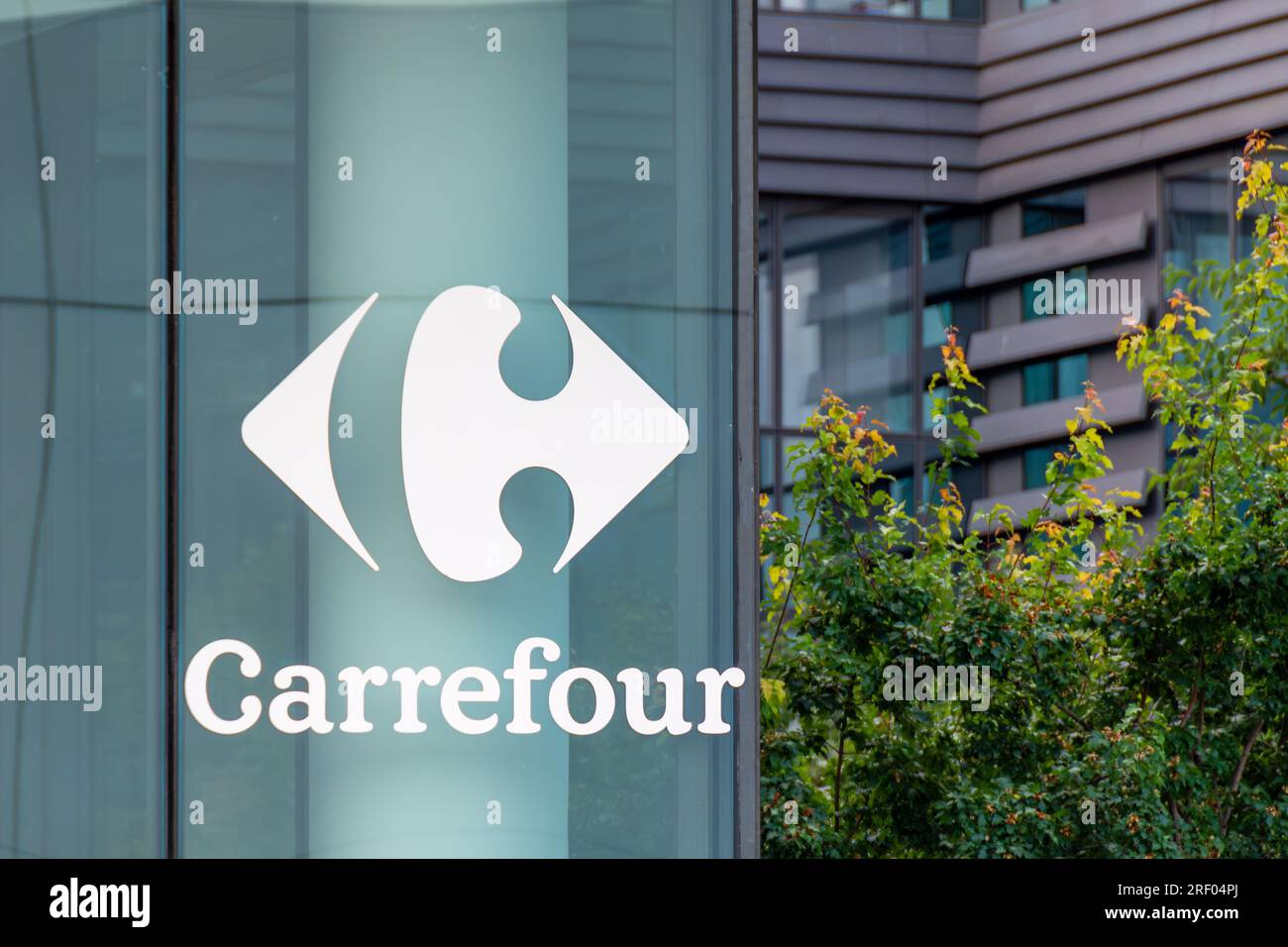 Sign and logo outside the building housing the world headquarters of Carrefour, a French multinational retail and wholesaling corporation Stock Photo