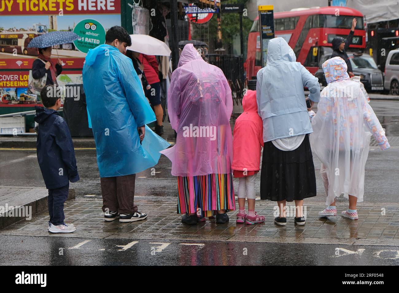 London, UK. 30th July, 2023. A heavy rain shower in Westminster causes