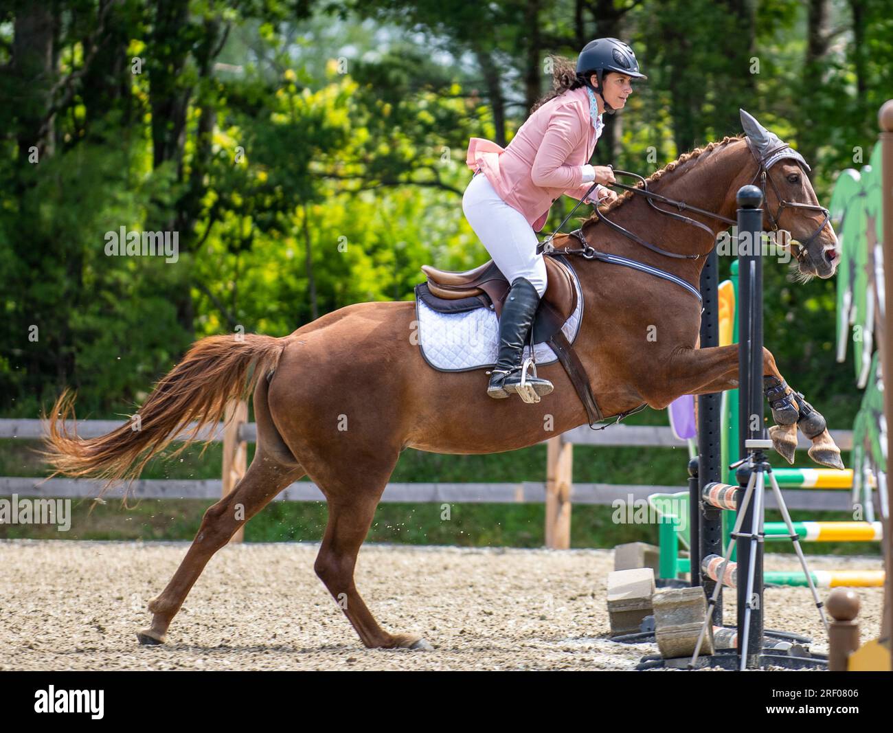 Courtney Guertin flies over a jump on her horse Jamila during a show jumping event at Sassy Strides Equestrian in Lisbon, Maine, on Sunday, July 30, 2023