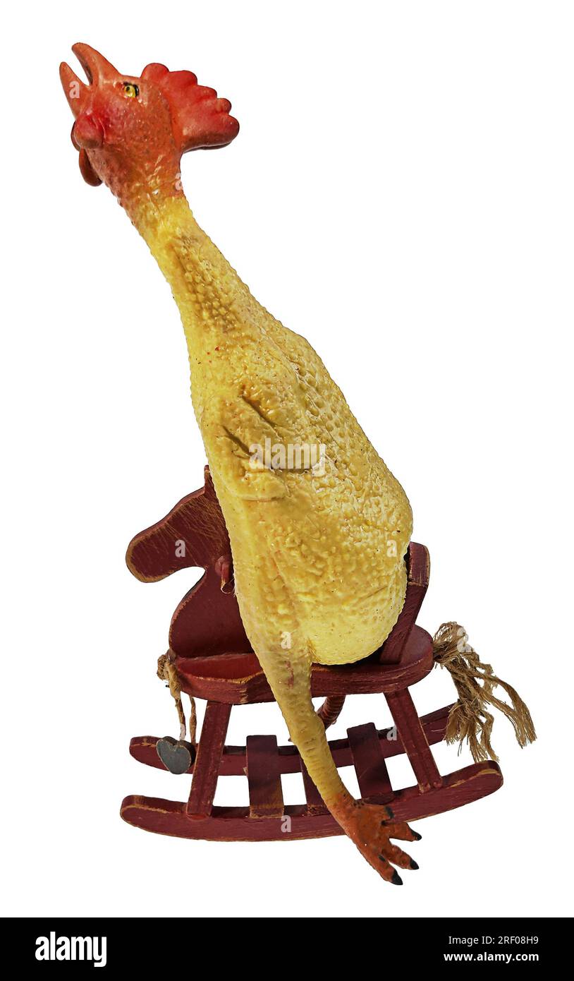 Rubber chicken in rocking horse showing jokes for kids Stock Photo