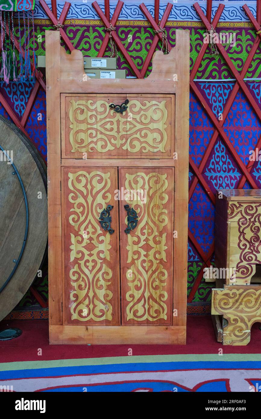 Kazakhstan, Almasai Gorge. Traditional Wood Carving Decorations on Furniture in a Restaurant. Stock Photo