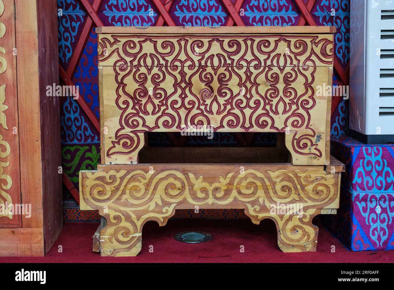 Kazakhstan, Almasai Gorge. Traditional Wood Carving Decorations on Furniture in a Restaurant. Stock Photo