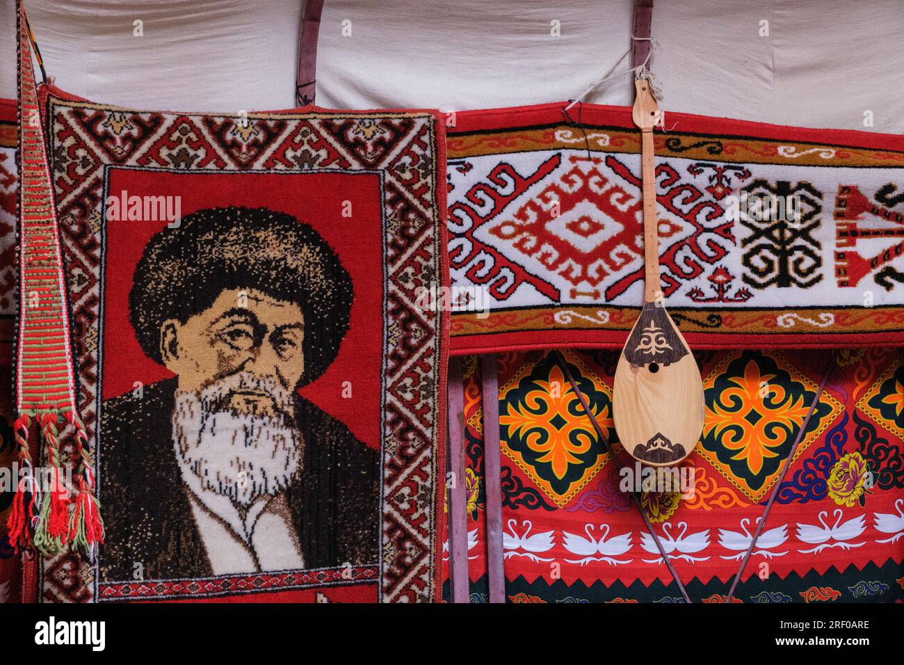 Kazakhstan, Saty. Yurt Interior Decorations. Kazakh Poet Zhambyl Zhabayev shown on rug decoration. Stock Photo