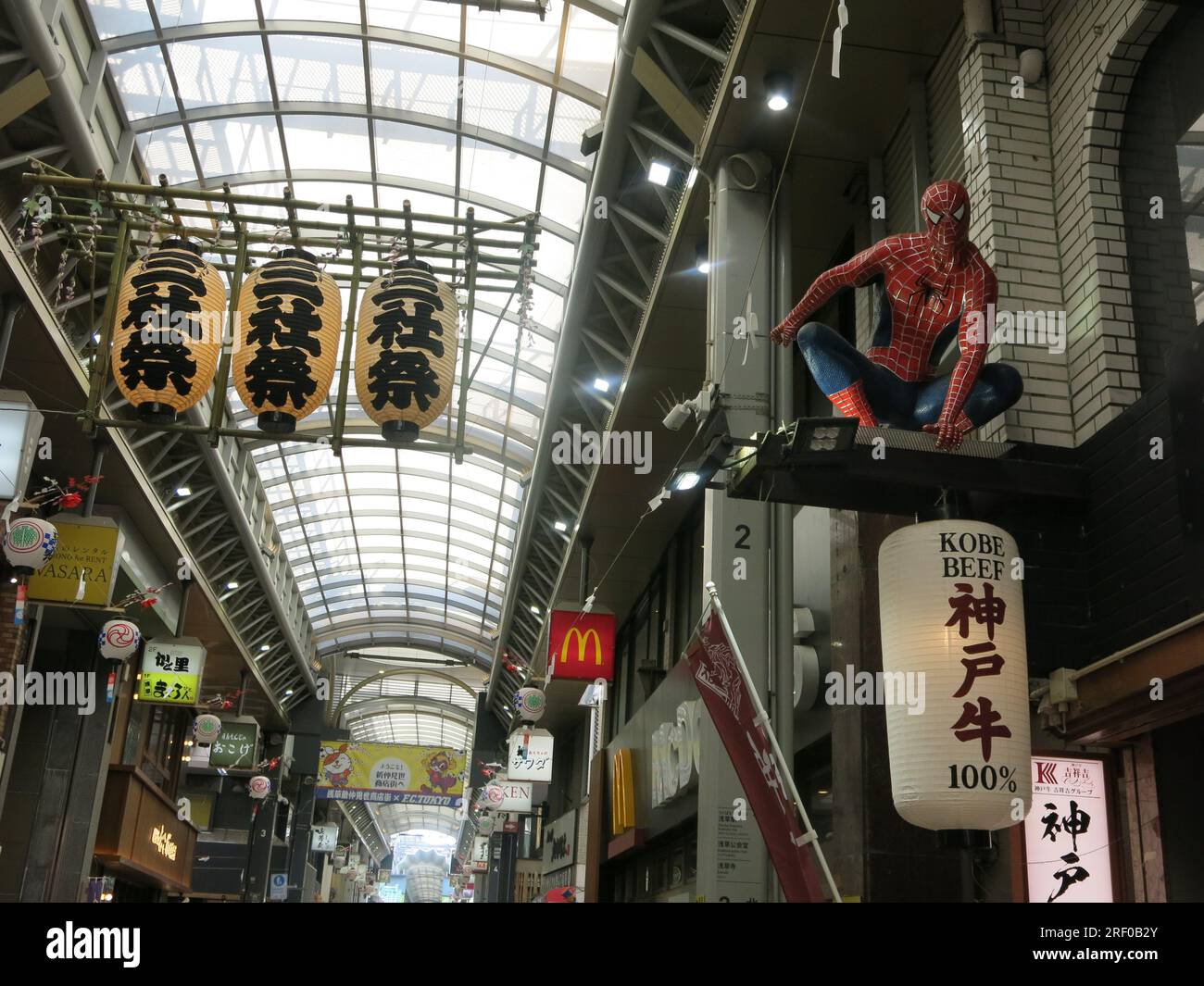 Spiderman and McDonalds are two of the recognisable icons in the Shin Nakamise covered arcade shopping street in Asakusa, a busy Tokyo tourist area. Stock Photo