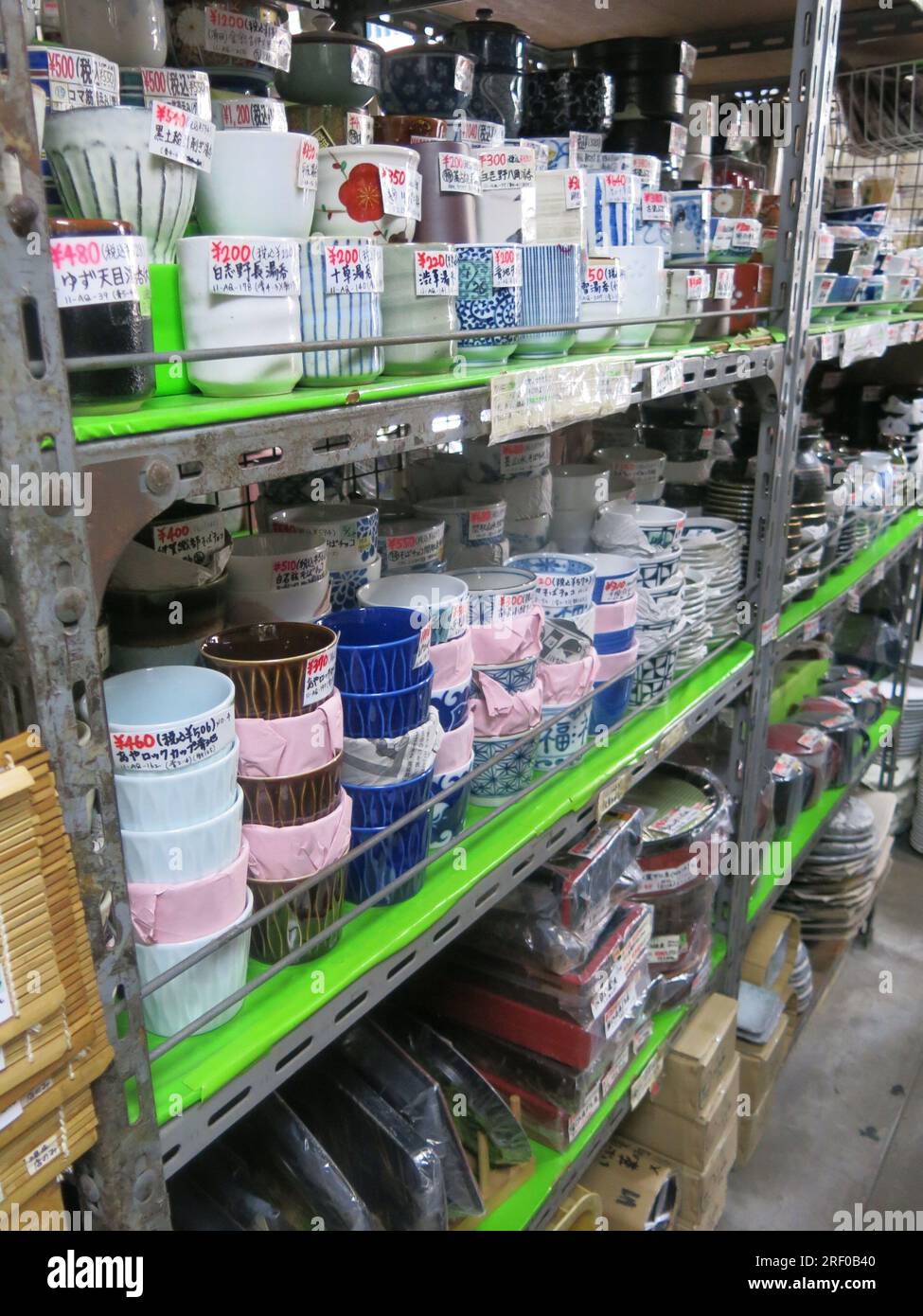 Piles of Japanese crockery & cookware on the shelves of a restaurant & catering supply shop on 'Kitchen Street', Kappabashi in Asakusa, Tokyo. Stock Photo