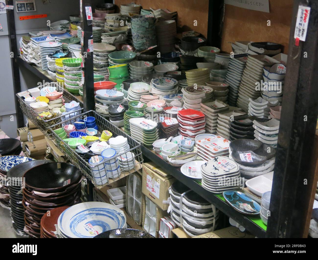 Piles of Japanese crockery & cookware on the shelves of a restaurant & catering supply shop on 'Kitchen Street', Kappabashi in Asakusa, Tokyo. Stock Photo