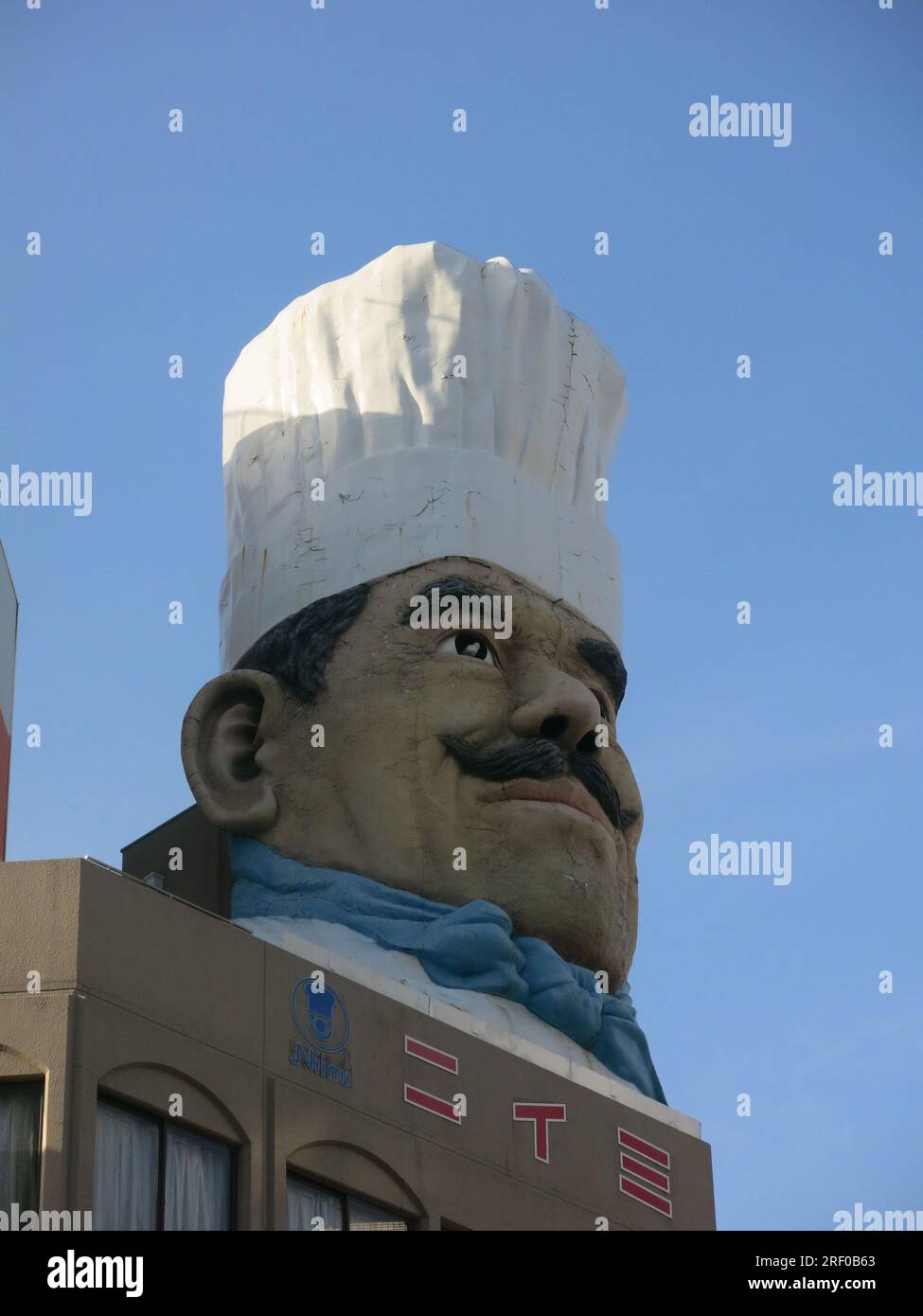 Giant model of a chef in a chef's hat on the top of a building on Kappabashi Street at the southern end of 'Kitchen Street', a Tokyo retail district. Stock Photo