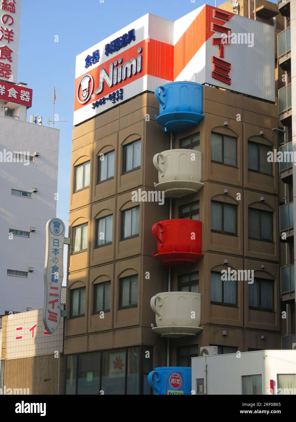 Giant coloured tea-cups adorn the corner of a multi-storey building on the southern end of Kappabashi Street, a shopping district for kitchen items. Stock Photo