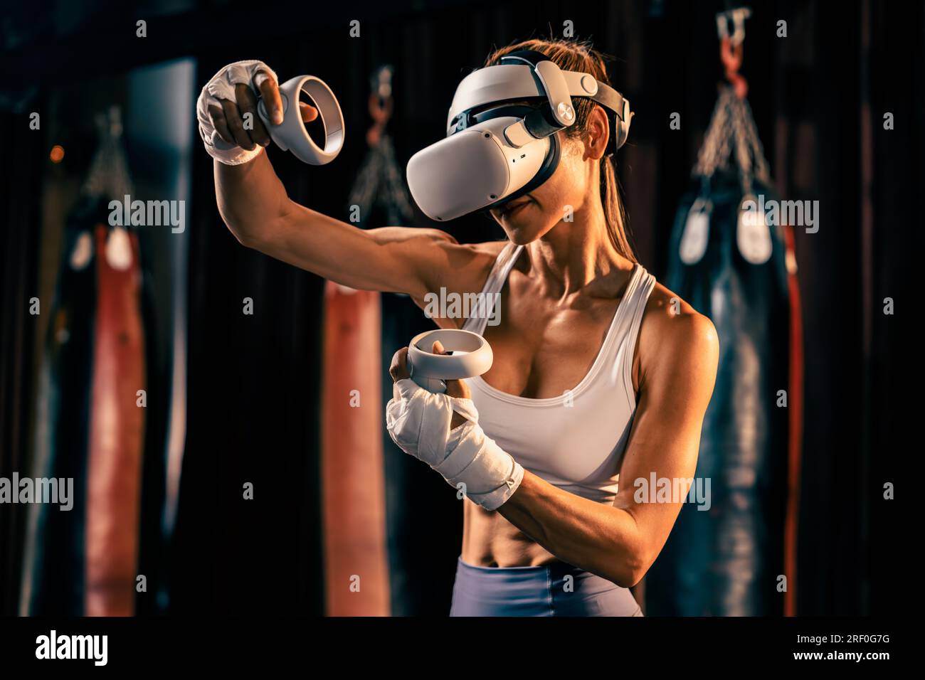 Female boxer training with VR or virtual reality, wearing VR headset