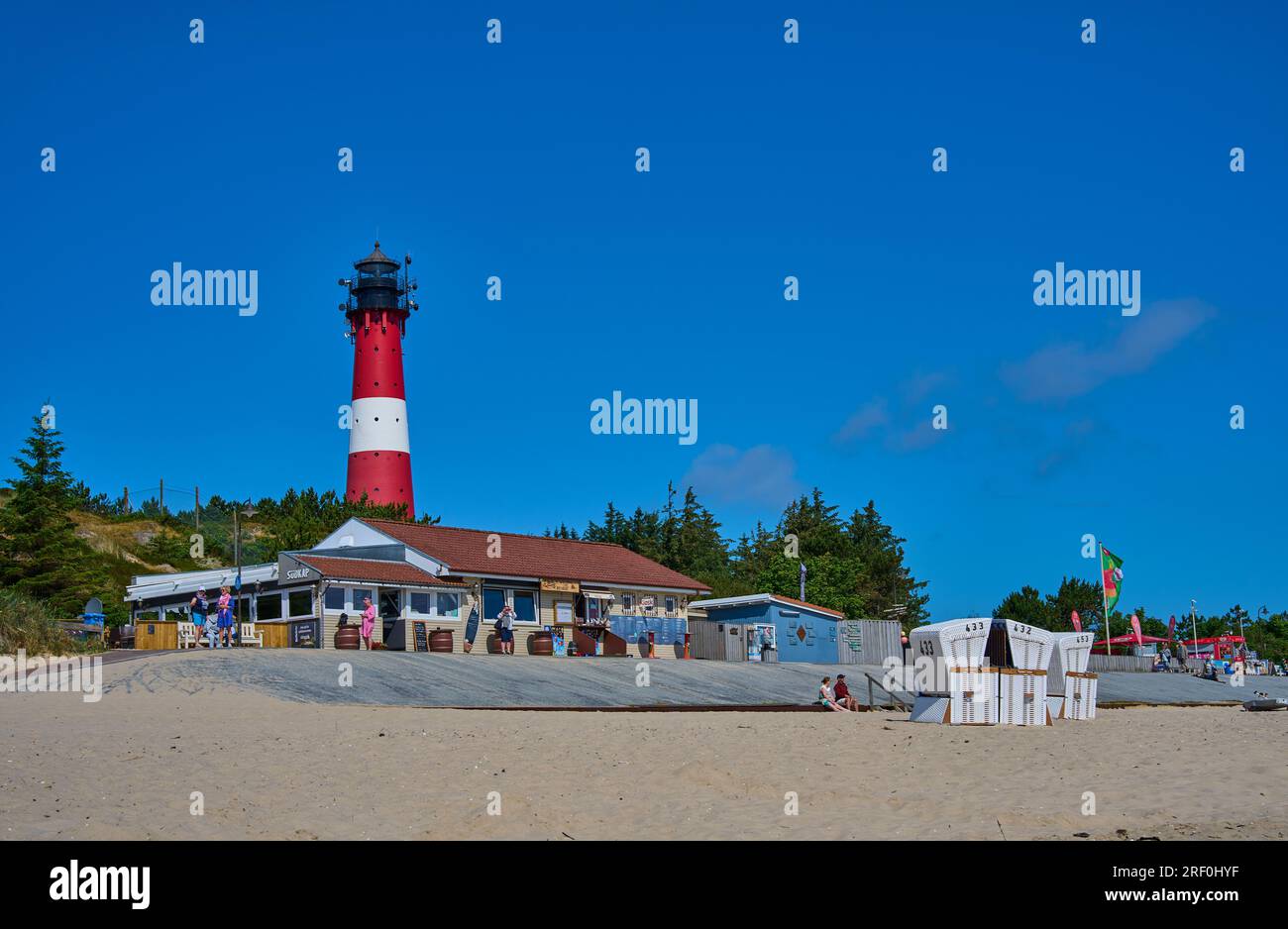 Tourists on the beach with lighthouse  on June 27, 2023   in Hörnum, Sylt Island, Germany.  © Peter Schatz / Alamy Stock Photos Stock Photo