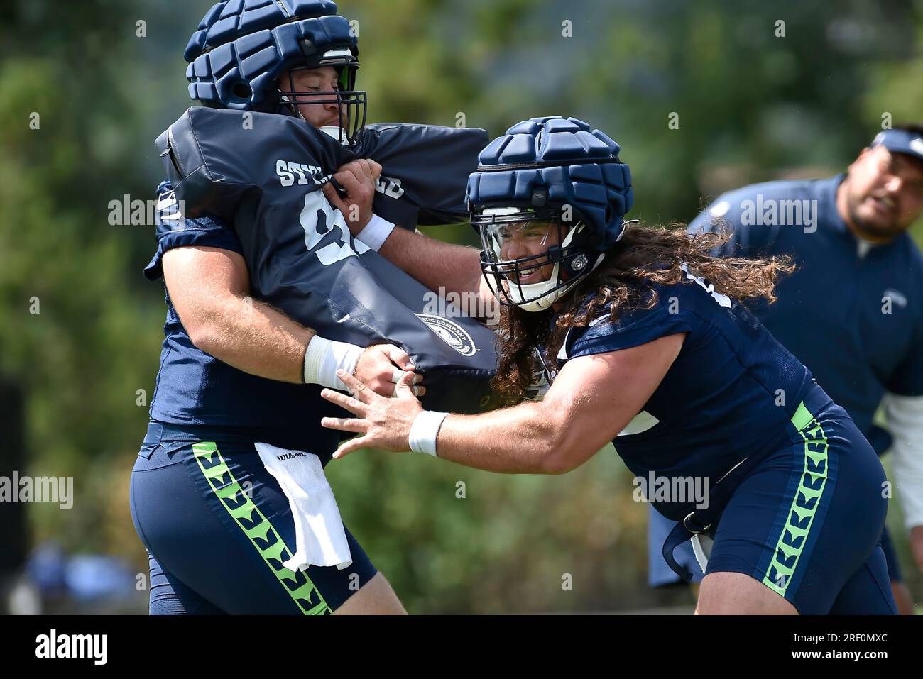 Seattle Seahawks center Joey Hunt (62) and offensive tackle Jalen McKenzie  (76) run a drill during the NFL football team's training camp, Wednesday,  Aug. 9, 2023, in Renton, Wash. (AP Photo/Lindsey Wasson