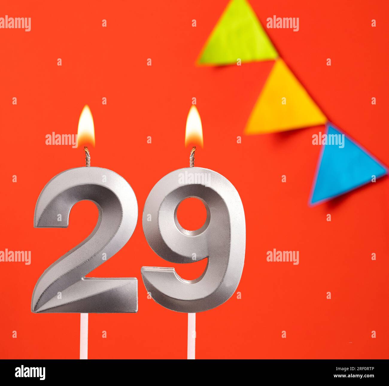 Birthday candle number 29 - Invitation card in orange background Stock Photo