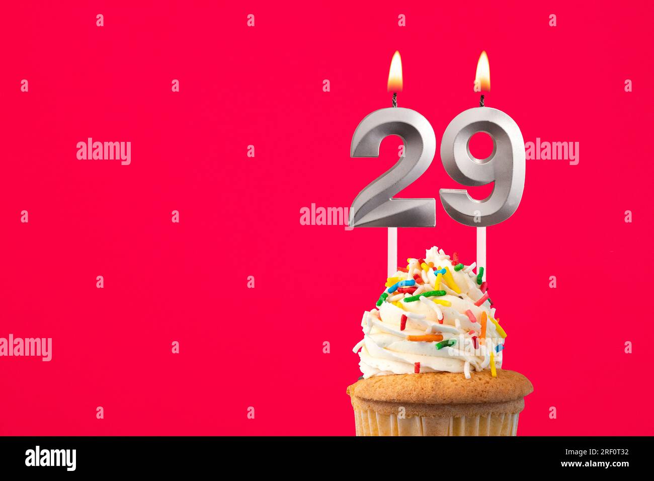 Horizontal birthday card with cake - Burning candle number 29 Stock Photo