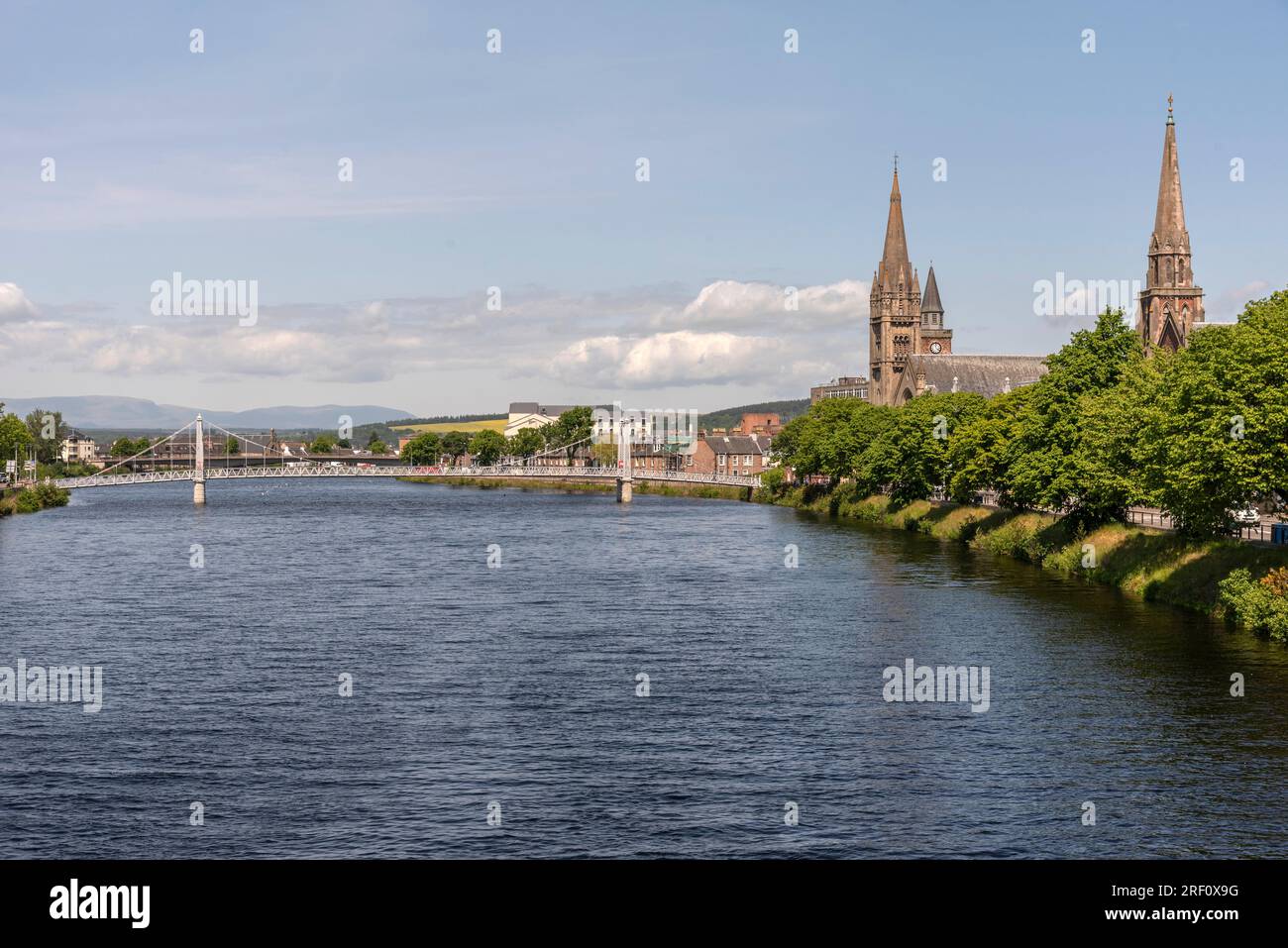 Inverness Scotland, UK. 3 June 2023.  View downstream of the River Ness and  Greig Street footbridge from Ness Bridge in the city centre. Stock Photo