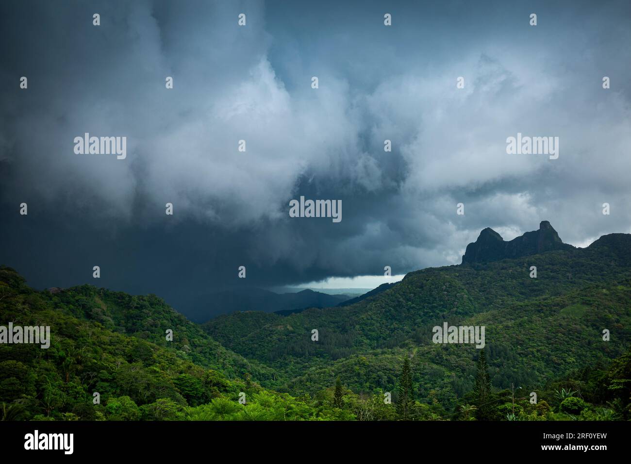 Heavy thunderstorm clouds rolling in on mountains in Panama Stock Photo