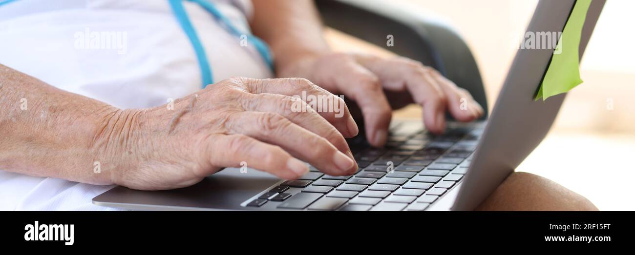Closeup of aged business woman using computer. Stock Photo
