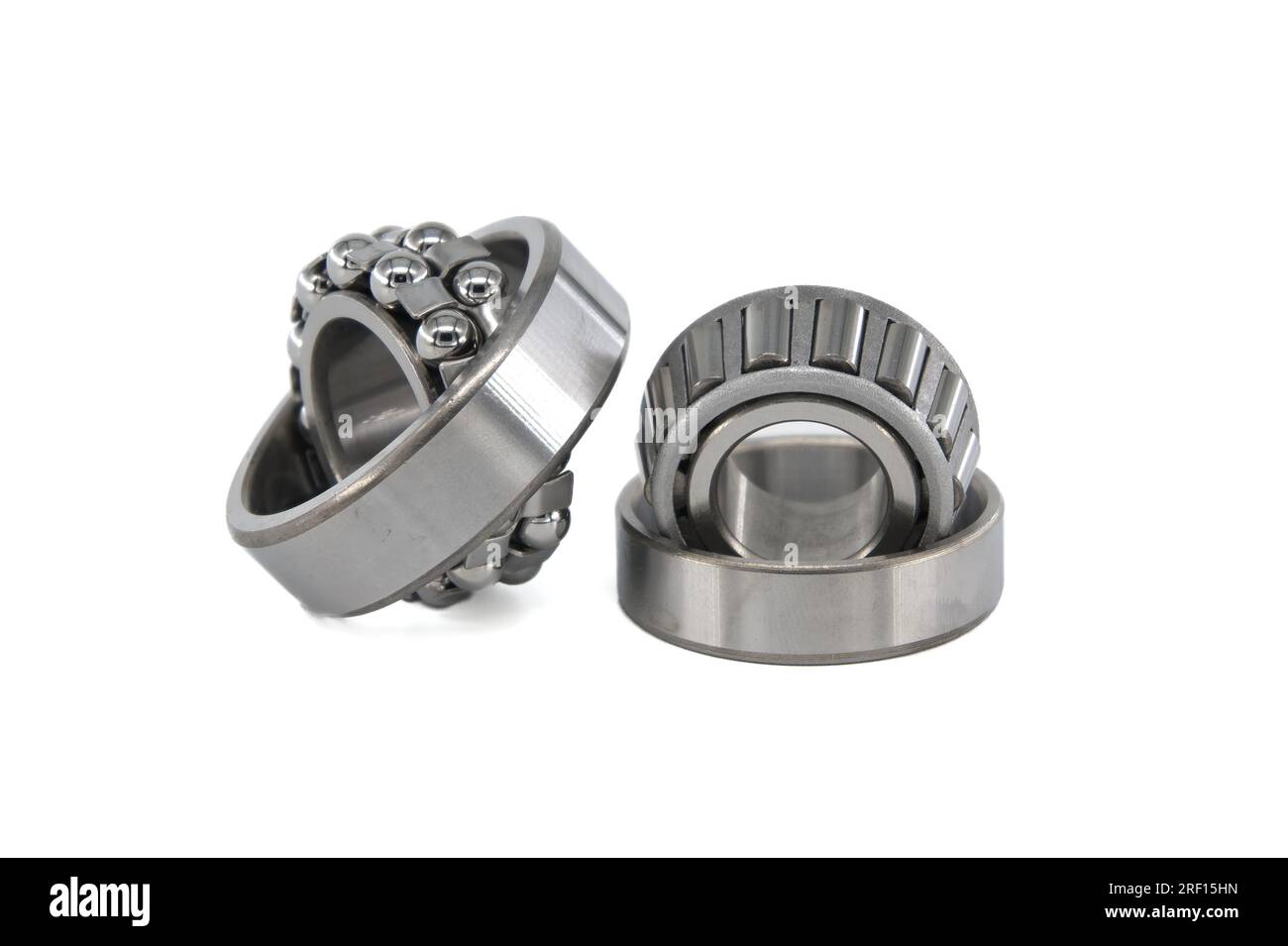 Ball bearings and tapered roller bearing isolated on white background