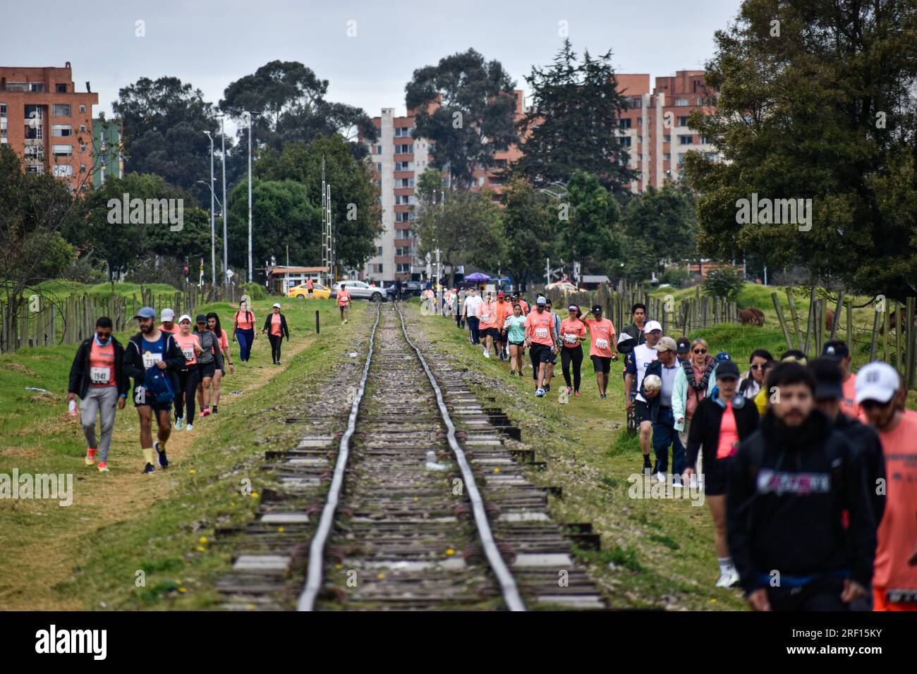 Bogota, Colombia. 30th July, 2023. Runners arrive by the train tracks