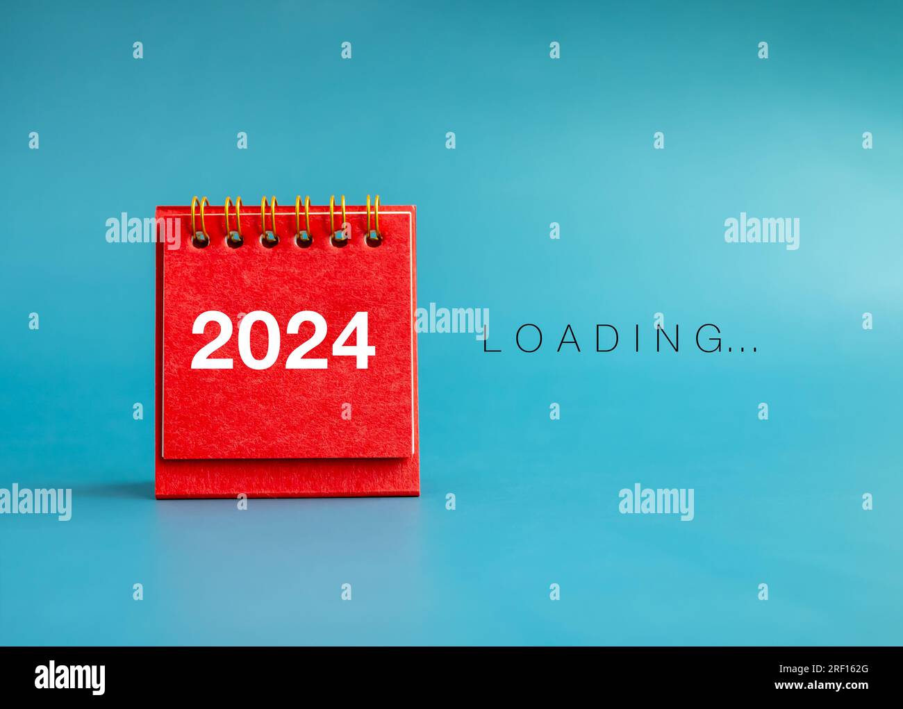 Loading to Merry christmas and happy new year 2024 banner background. Loading, text appears beside small red desk calendar with 2024, white year numbe Stock Photo