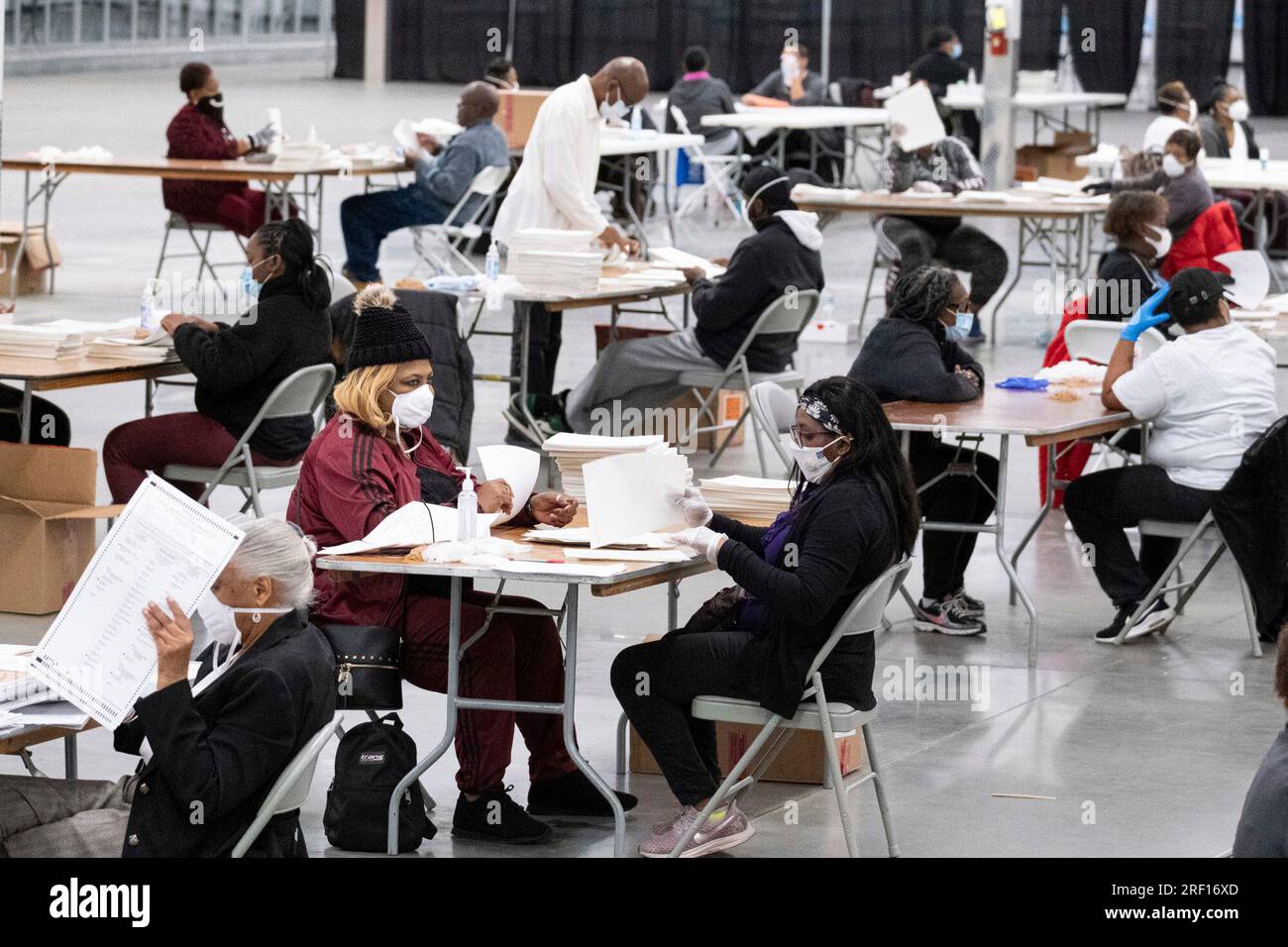 FILE Workers sort and stack ballots in preparation for scanning as