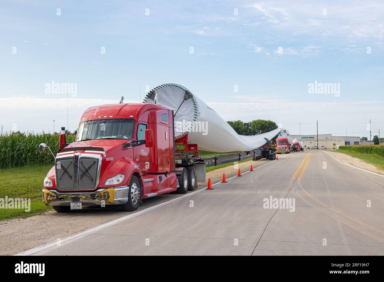 A truck convoy of wind turbine blades being staged at the Siemens
