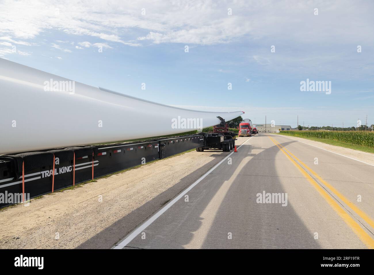 A truck convoy of wind turbine blades being staged at the Siemens