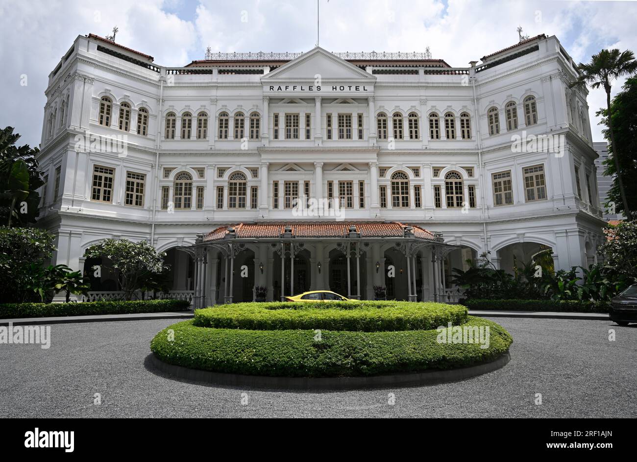Singapore - July 27, 2023; Historic Raffles Hotel Exterior and forecourt on a hot summer day, Singapore. Stock Photo