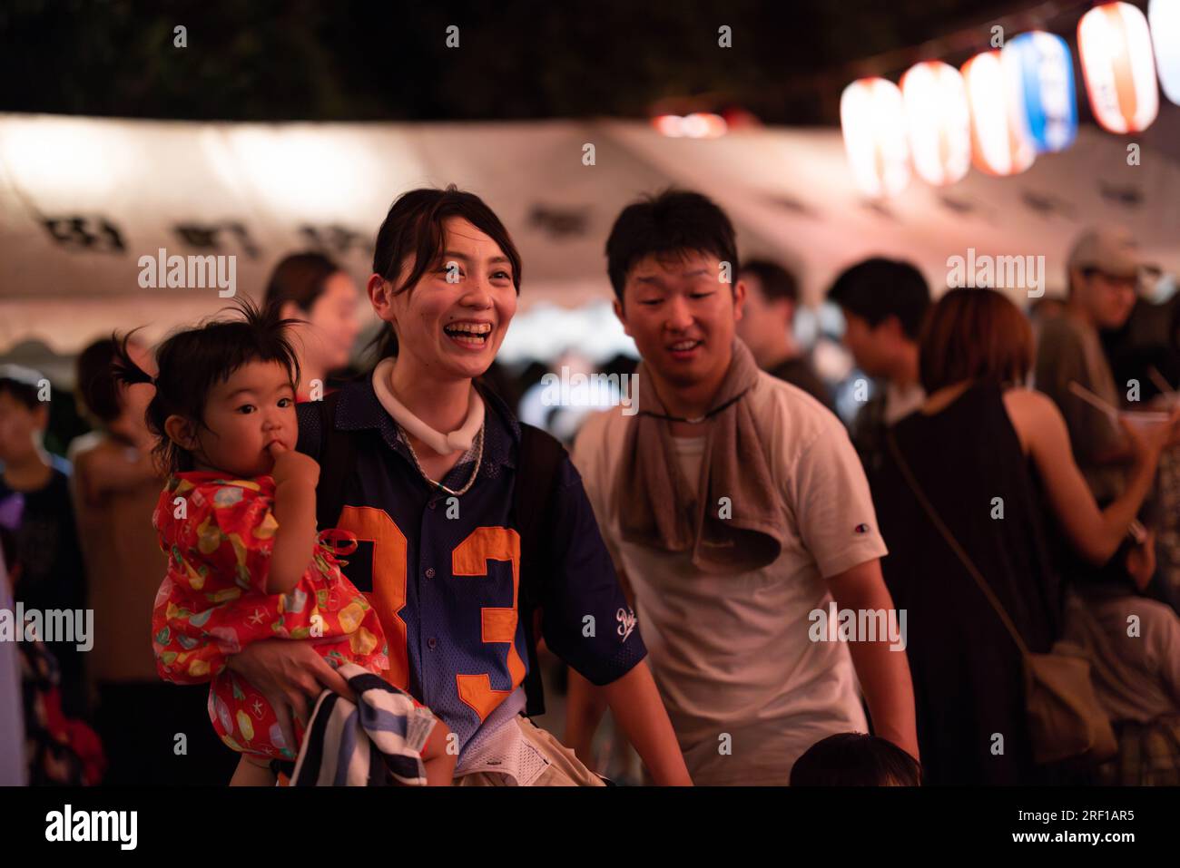 Yokohama, Japan. 29th July, 2023. Family enjoys their time at a bon odori matsuri (summer festival) at Sugiyama shrine. After the Japanese government declared the end of the Coronavirus pandemic in May 2023, the traditional summer festivals have returned to shrines and temples all over the country. Credit: SOPA Images Limited/Alamy Live News Stock Photo