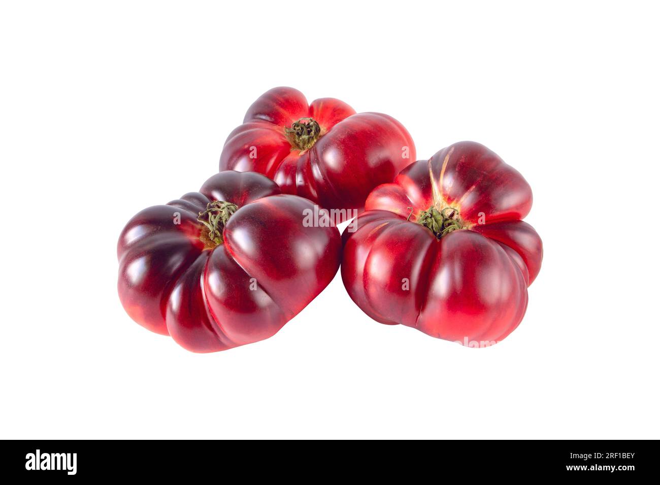 Blue tomato vegetables heap isolated on white background. Purple solanum lycopersicum ripe fruit. Stock Photo
