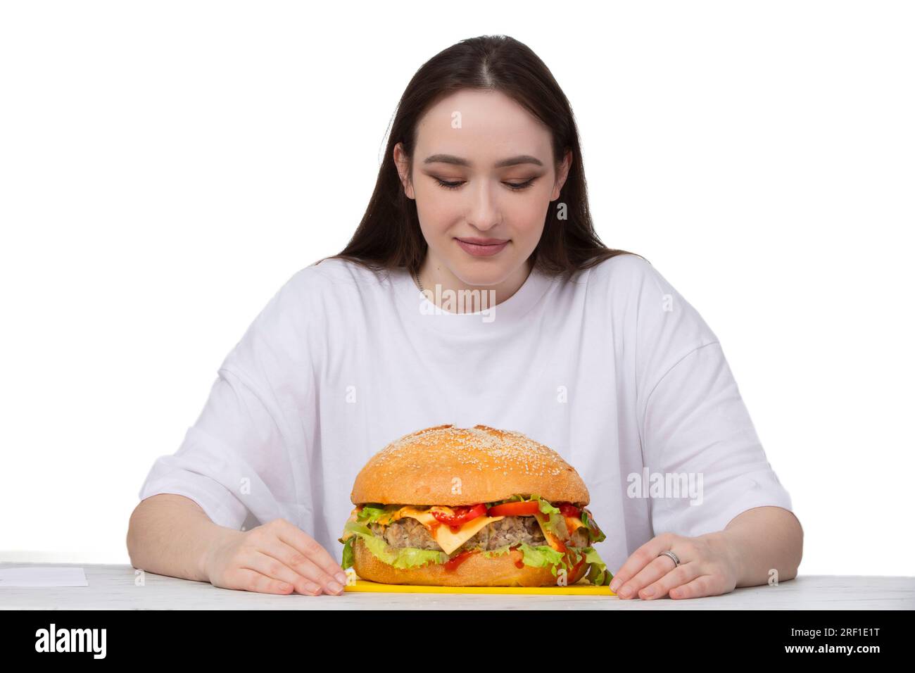 A woman is holding a big barbecue hamburger sandwich on the background ...