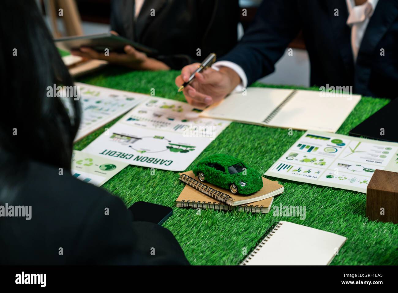 Group of business people planning strategic marketing in electric car company meeting for eco