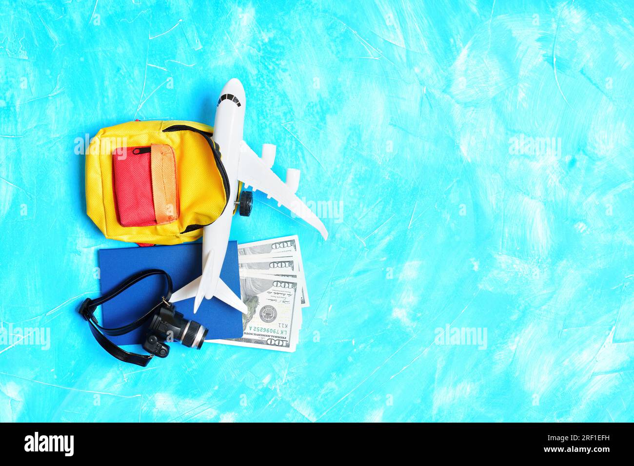 Traveling by plane Toy airplane model, vibrant backpack, passport with