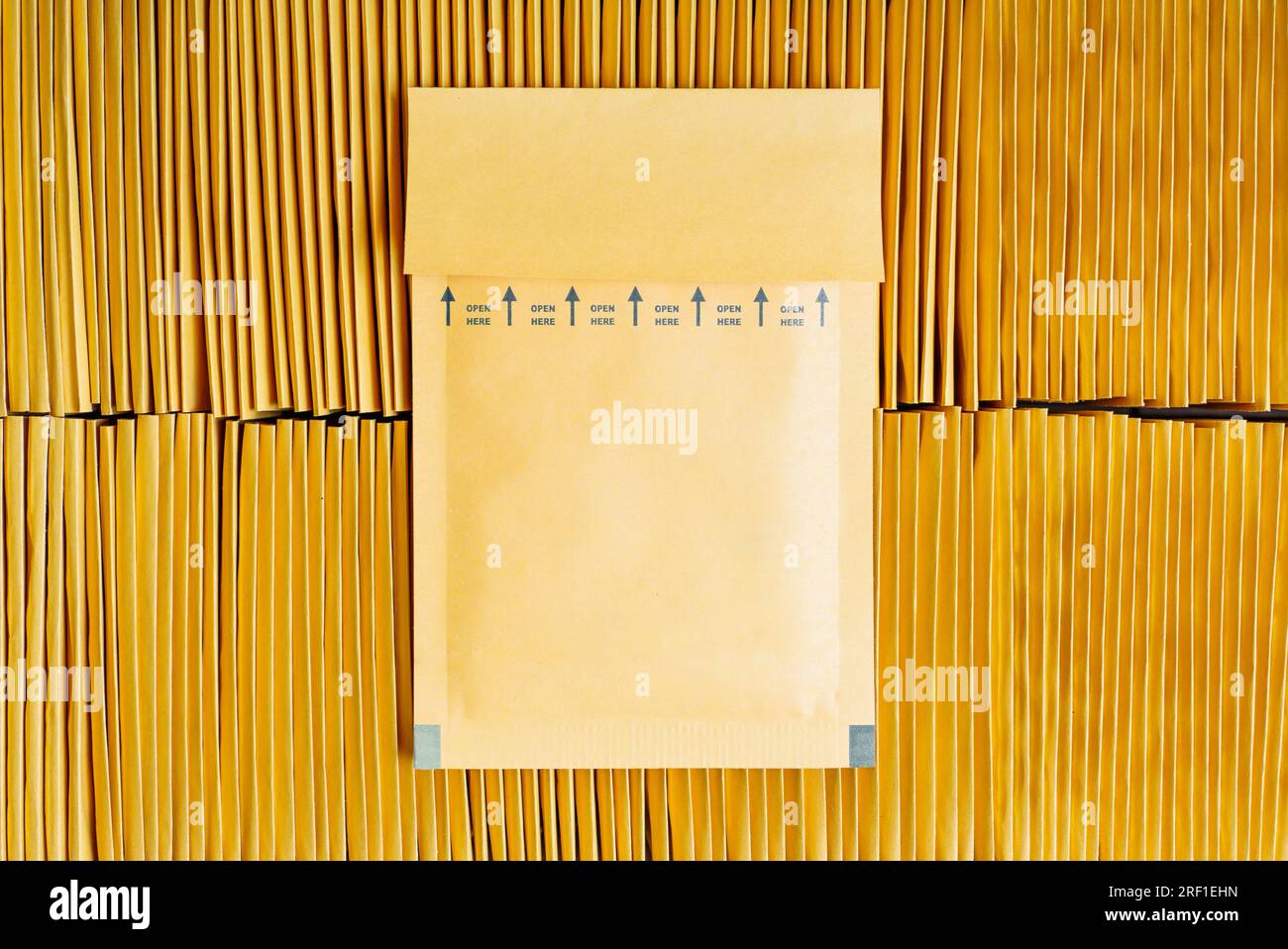 Two stacks of yellow envelopes in a kraft cardboard box isolated on white.  Office supplies Stock Photo - Alamy