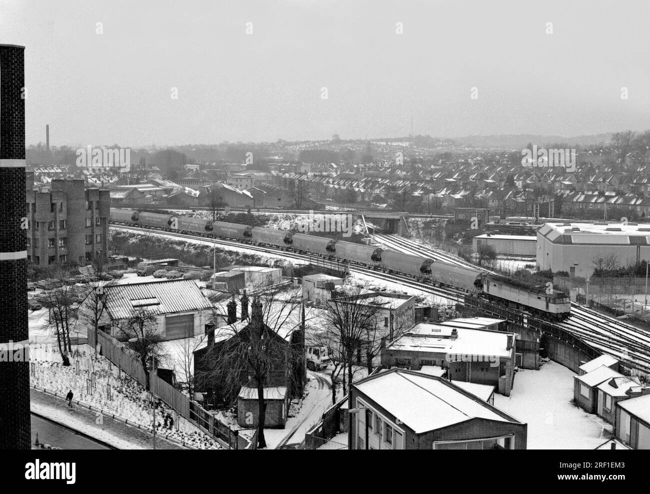 A Class 47 diesel locomotive number 47292 with a rake of JIA Polybulk wagons approaching a snow covered Lewisham on the 15th February 1994. Stock Photo