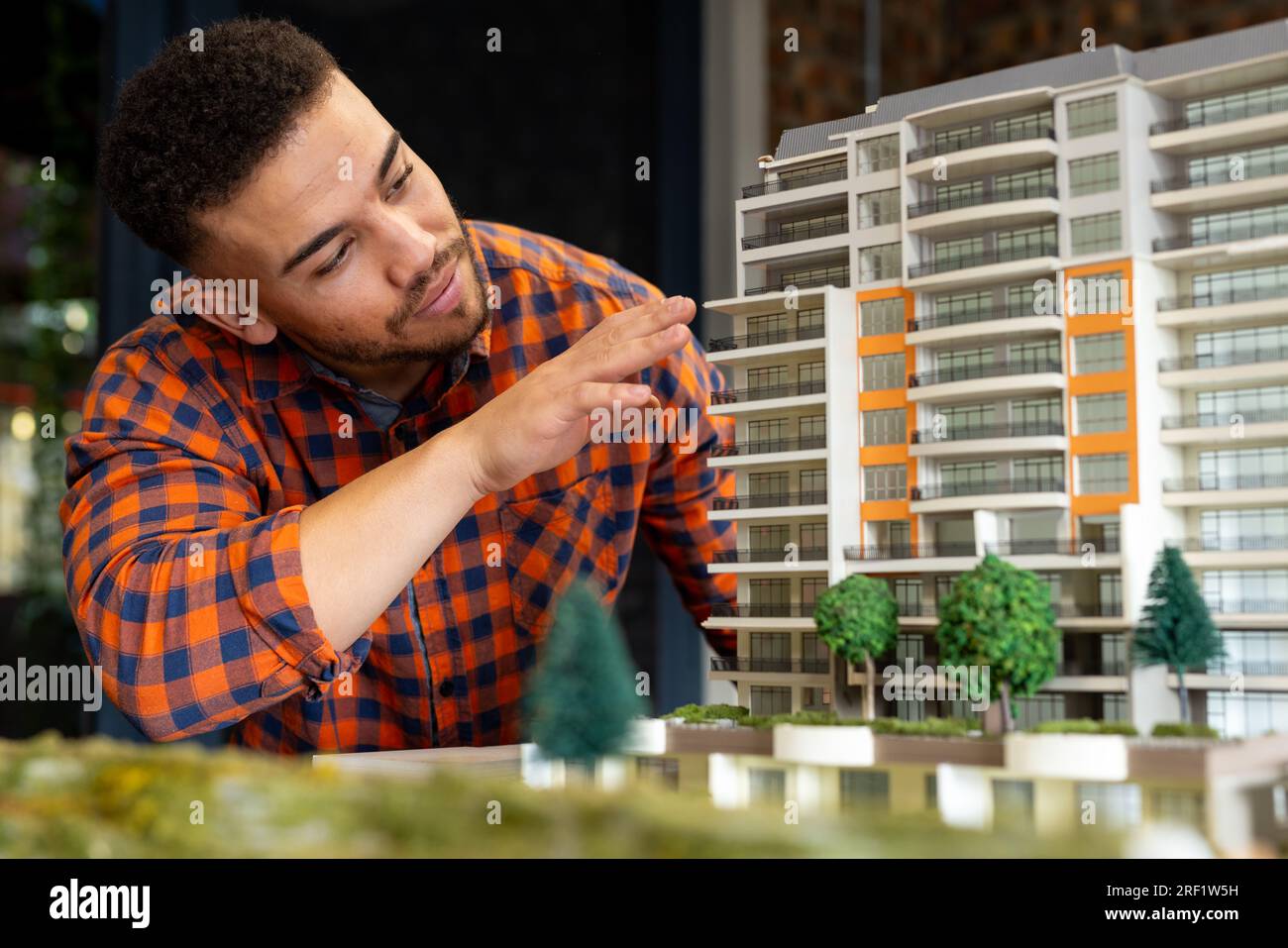 Biracial male architect working on a building model at office Stock Photo